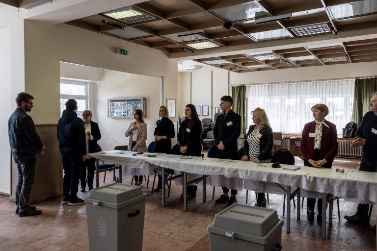 12 April 2026, Boldog, Hungary. Parliamentary election day. Polling station no. 1. The electoral commission gives a warm welcome to a voter who is casting a ballot for the first time in their life.