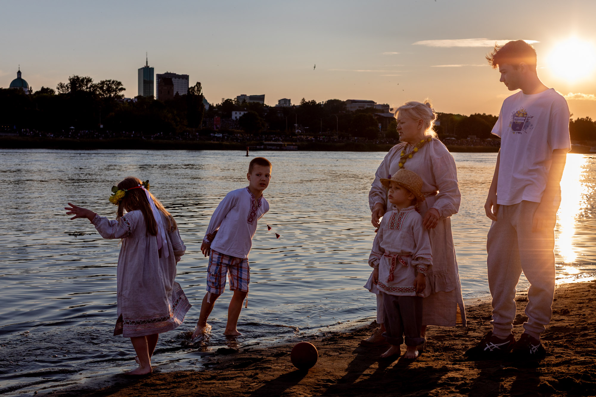 Anna Kanavalava and the children on the banks of the Vistula, throwing flowers into the river during a Belarusian ceremony