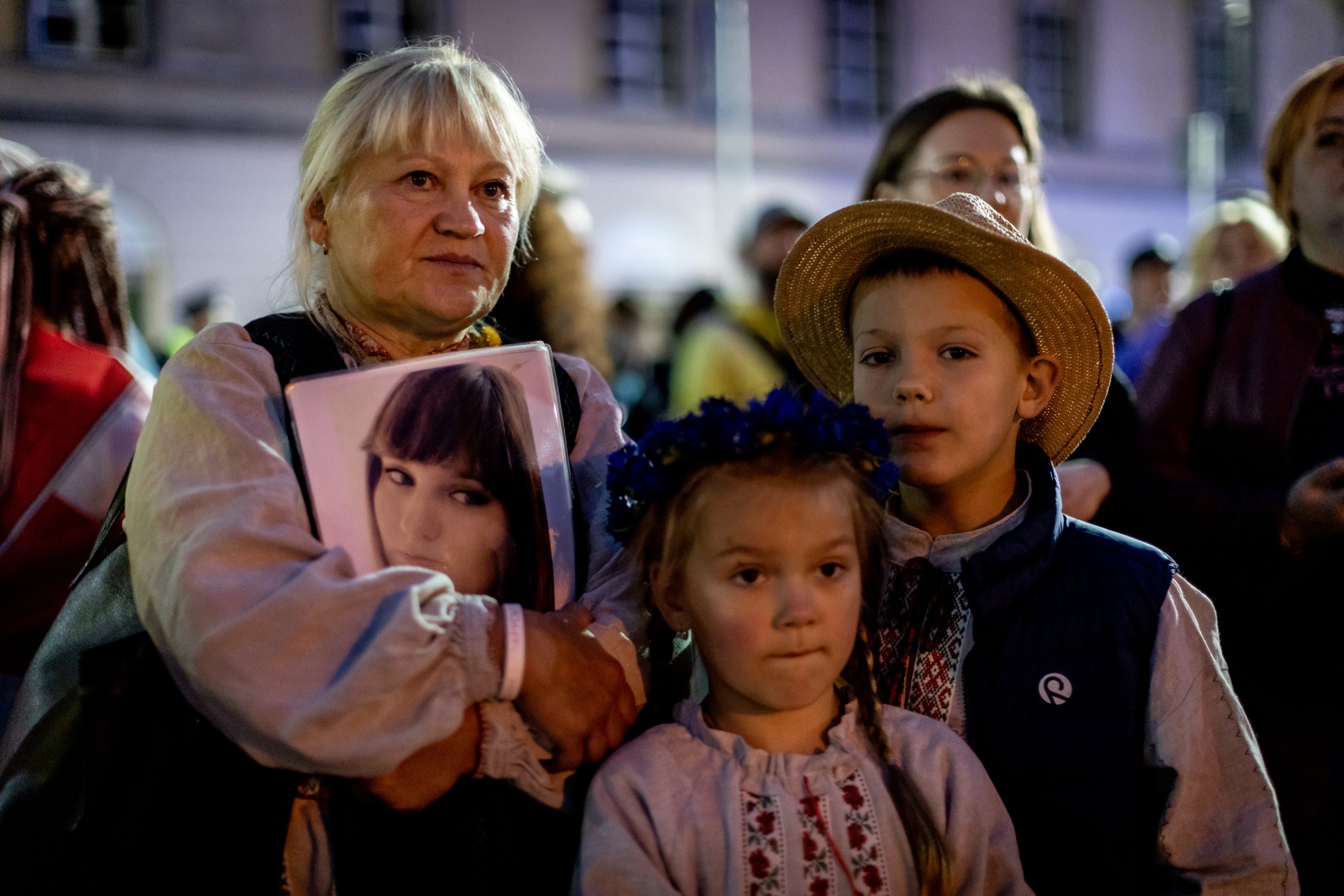 Anna Kanavalava and her grand children
during the Belarusian demonstration marking the third anniversary of the rigged presidential election in Belarus.